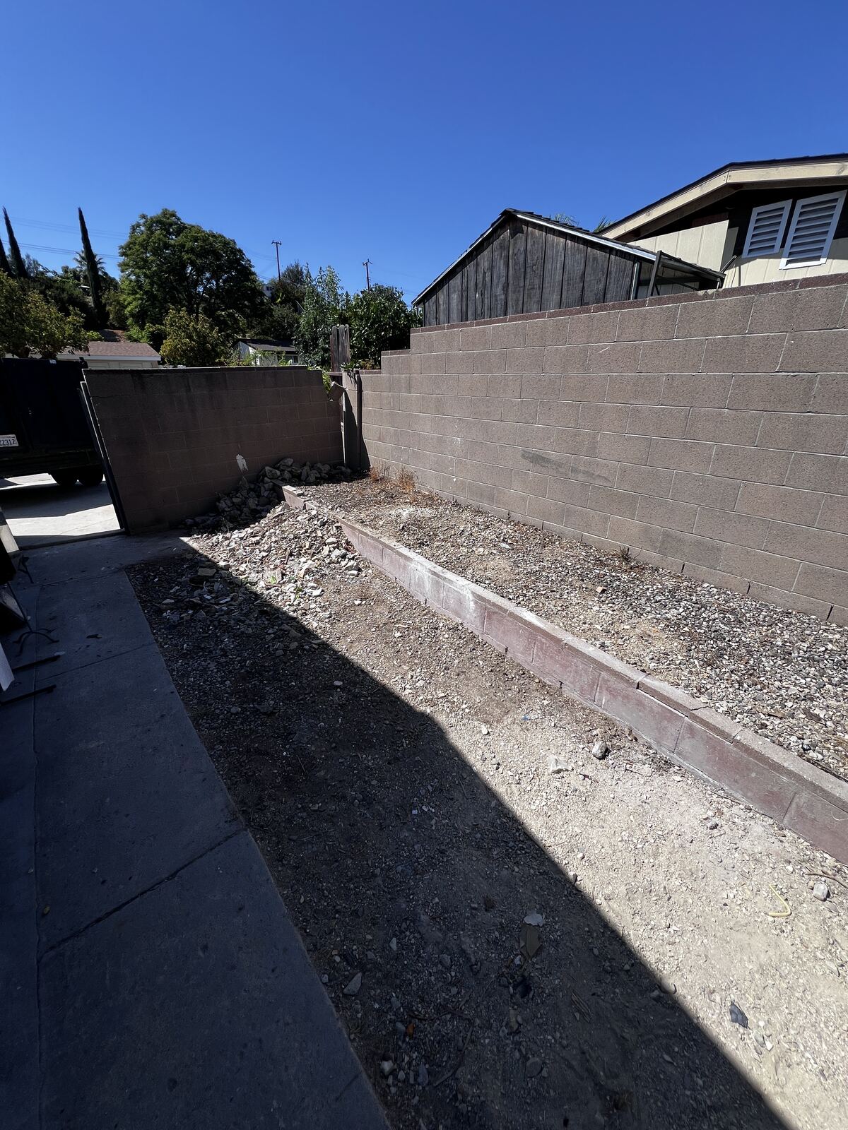 Same side yard cleared down to gravel after cleanup
