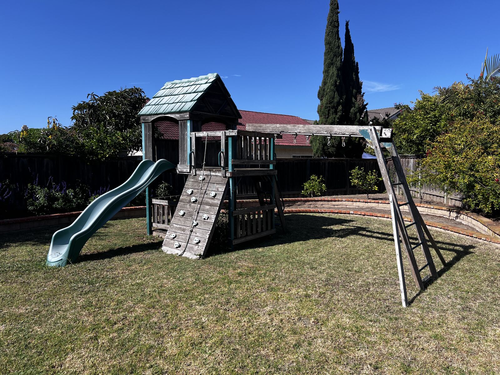 Old worn wooden play structure before removal